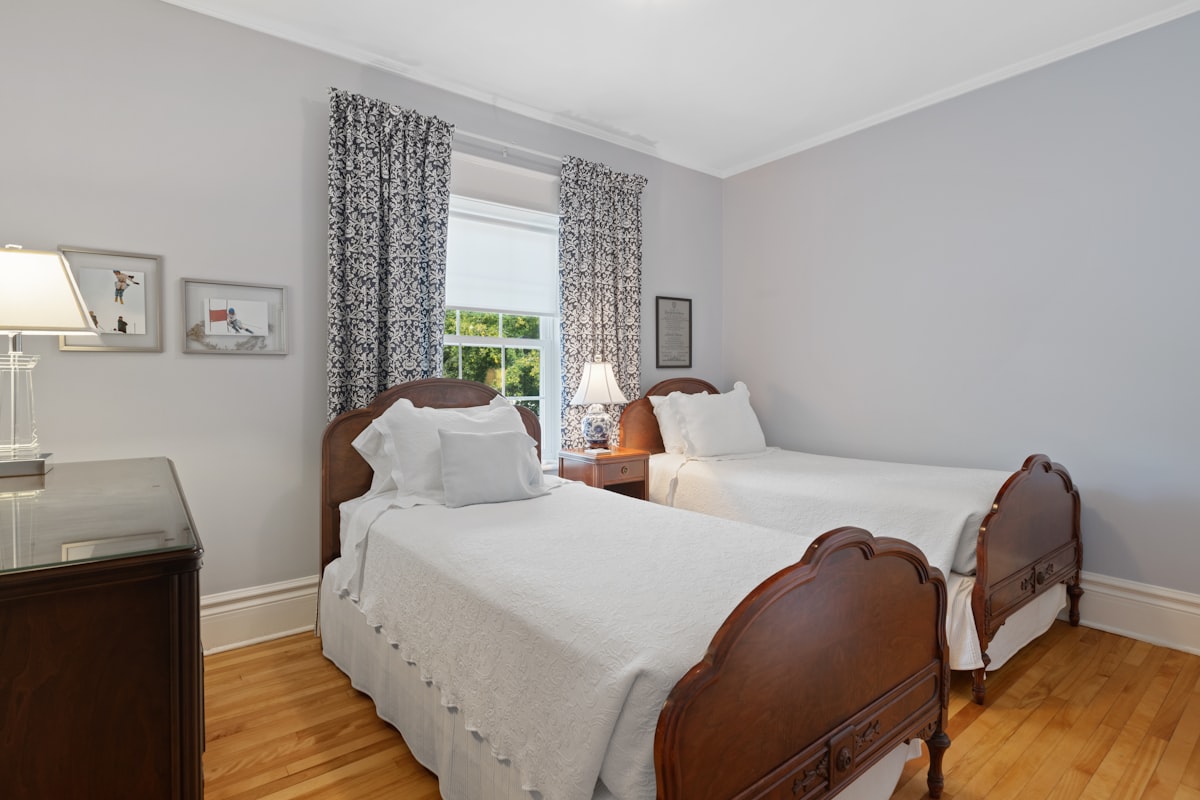 a bedroom with two beds and a desk related to Embrace Cozy Comfort: Exploring the Ultimate Twin Size Bed Experience