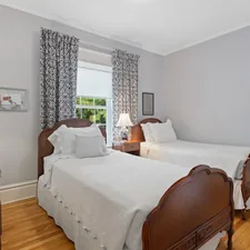 a bedroom with two beds and a desk related to Embrace Cozy Comfort: Exploring the Ultimate Twin Size Bed Experience
