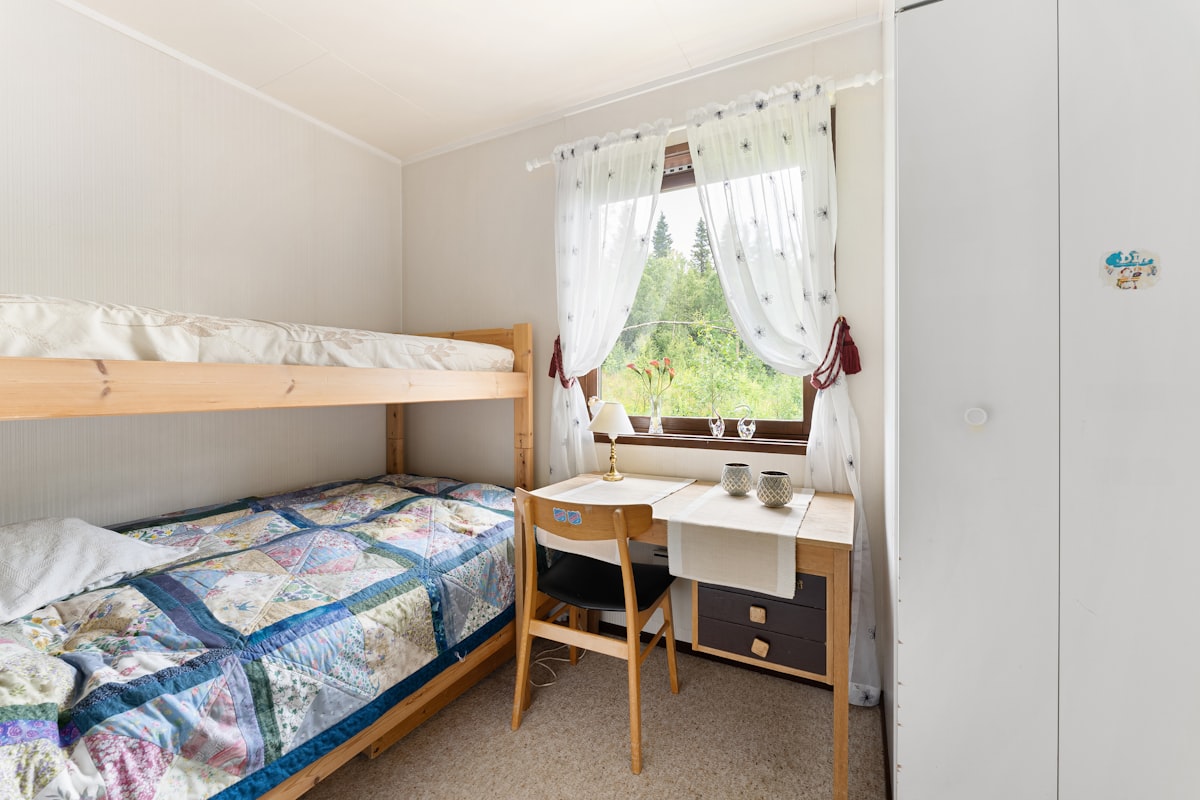 A bedroom with two bunk beds and a desk related to Maximizing Bedroom Space with a Twin Over Full Bunk Bed
