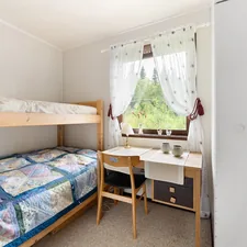 A bedroom with two bunk beds and a desk related to Maximizing Bedroom Space with a Twin Over Full Bunk Bed