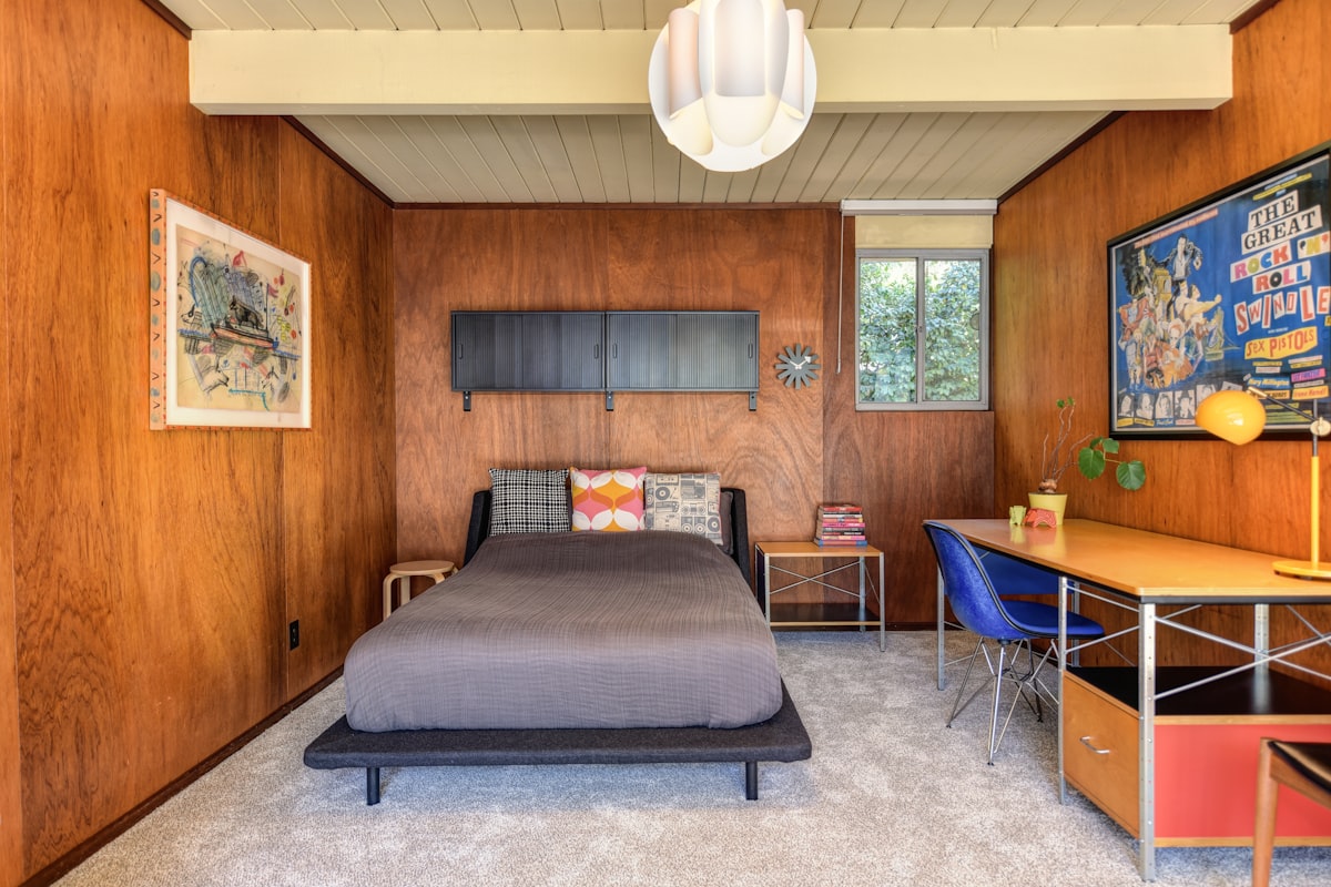 a bedroom with wood paneling and a bed related to Sleek and Sophisticated: The Ultimate Guide to Mid Century Modern Beds