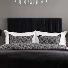 A black and white bedroom with a chandelier related to Black Quilts and Coverlets: Elegant Home Decor