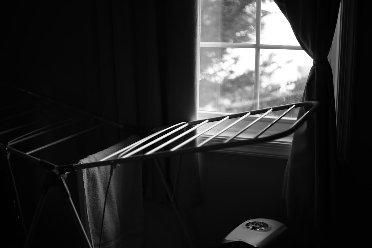 A black and white photo of a bed and a window related to Timeless Elegance: Black and White Crib Bedding for Your Little One