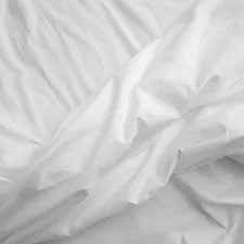 a black and white photo of a bed with white sheets related to White King Size Coverlet
