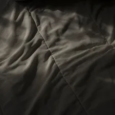 a black and white photo of a blanket related to Coverlet vs Bedspread: Which One Should You Choose?