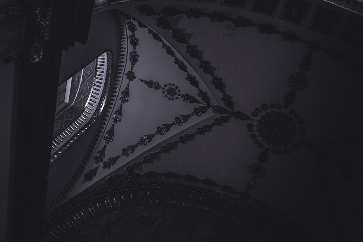 A black and white photo of a clock related to The Elegance of the Black King Canopy Bed: A Luxurious Addition to Your Bedroom