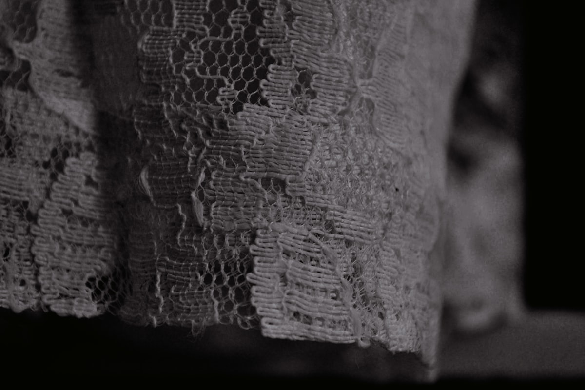 A black and white photo of a lace curtain related to The Art of Adding Elegance with Lace Window Valances