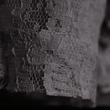 A black and white photo of a lace curtain related to The Art of Adding Elegance with Lace Window Valances