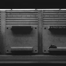 a black and white photo of a row of urinals related to The Perfect Storage Bench for Your Entryway: Organize Your Home in Style