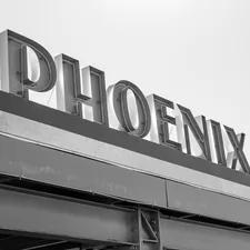 a black and white photo of a sign for a store related to Discover Top Shopping Destinations in Phoenix