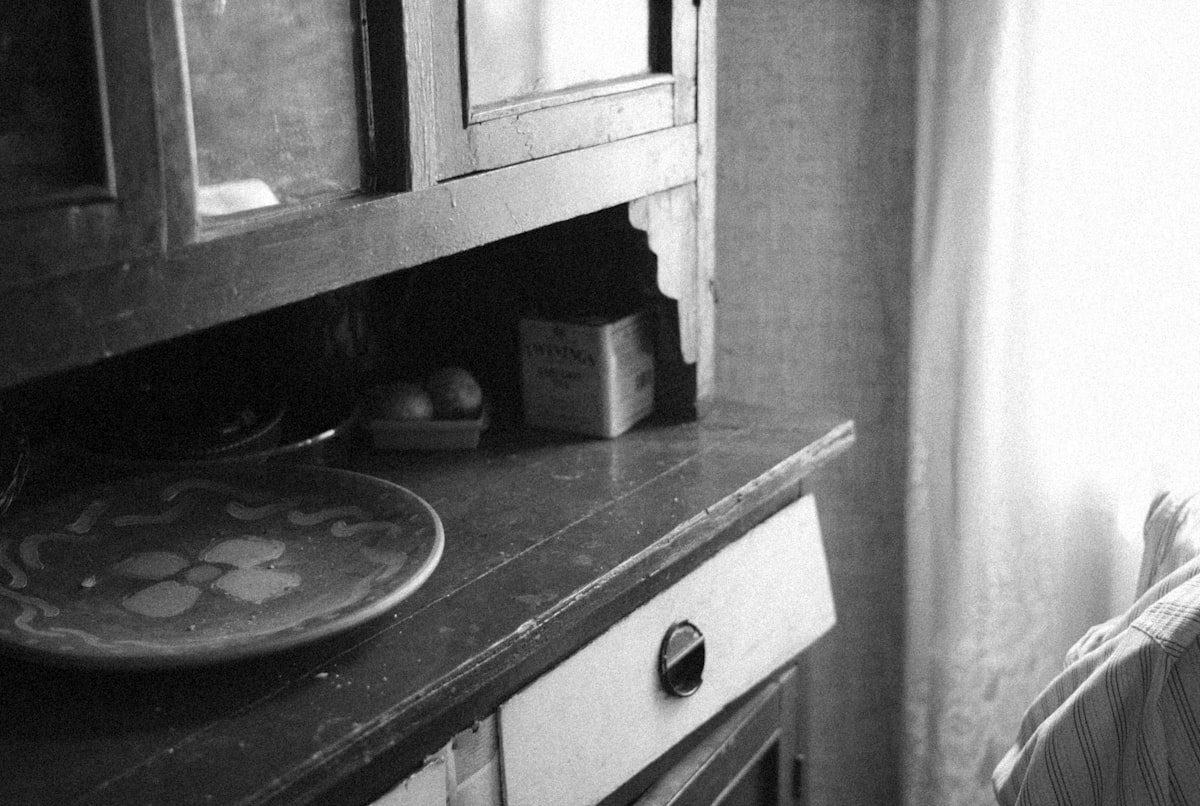 a black and white photo of a sink in a kitchen related to Mastering the Art of Sideboards and Hutch Storage Solutions
