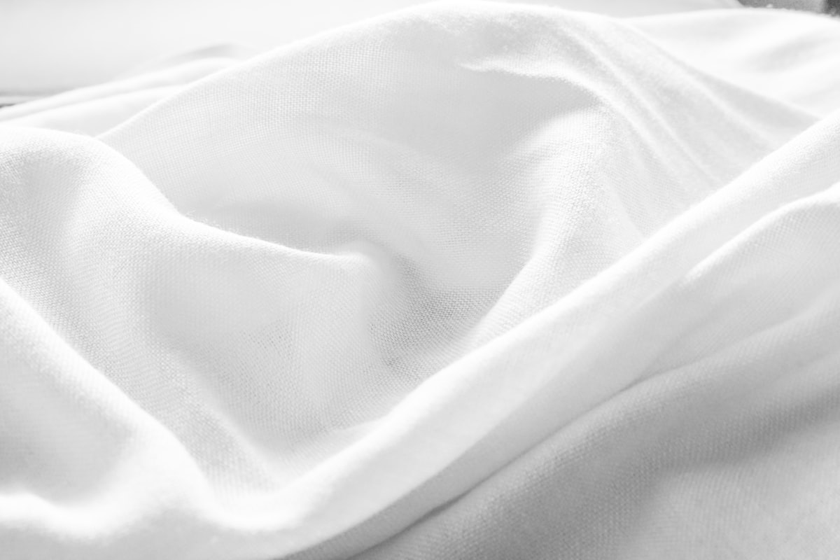 a black and white photo of a white blanket related to Silk Coverlet King: The Ultimate Guide