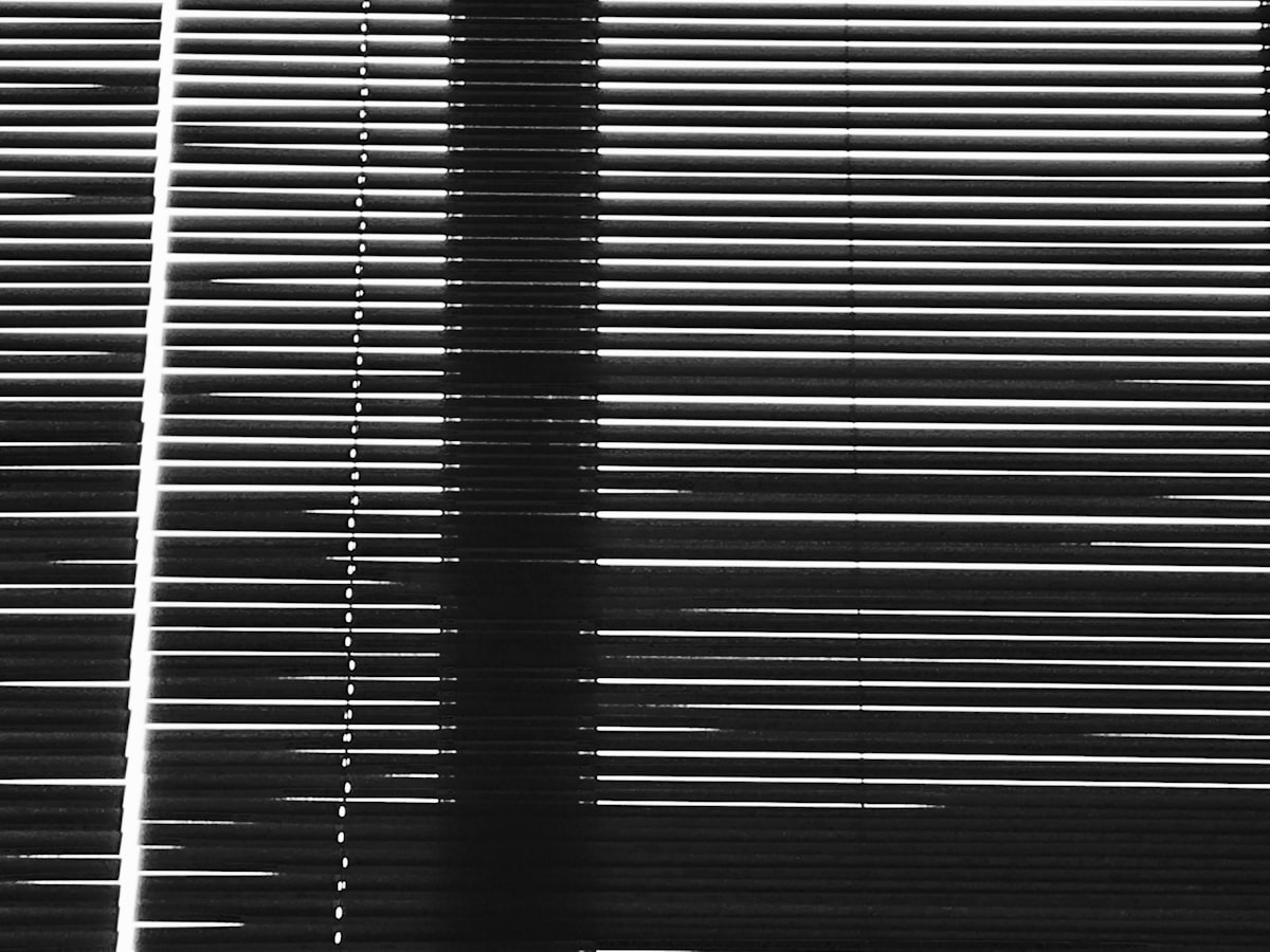 a black and white photo of a window with blinds related to Striped Valances Window Treatments