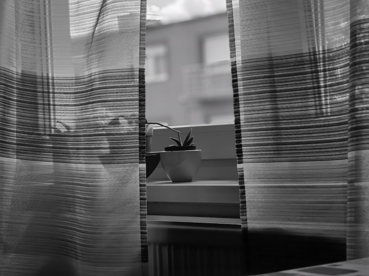 a black and white photo of a window with curtains related to Striped Curtain Valances