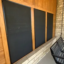 A black bench sitting next to a brick wall related to Black Valance with Grommets
