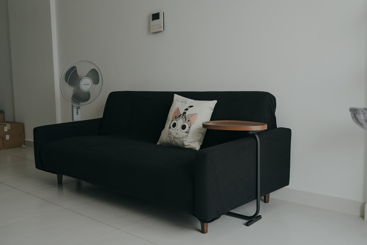 a black couch with a wooden table on top of it related to Cozy Up to Savings: Sofa Bed Sale You Won't Want to Miss
