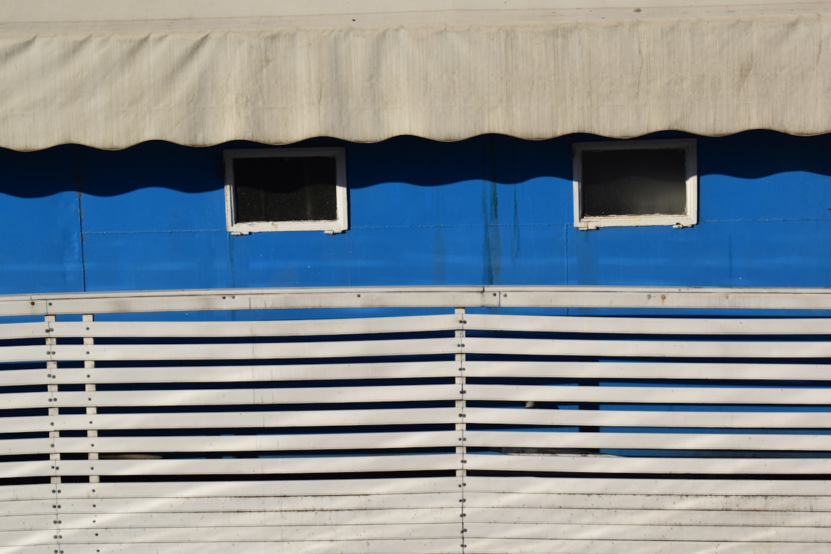 a blue and white building with two windows related to Royal Blue Window Valance: Elevate Your Window Decor