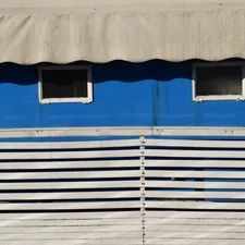 a blue and white building with two windows related to Royal Blue Window Valance: Elevate Your Window Decor