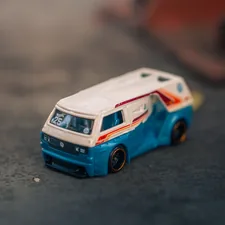A blue and white toy van on a dark surface. related to Speed into Slumber with the Ultimate Hot Wheels Bedding Set