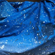 a blue cloth covered in white speckles related to Cosmic Dreams: The Joy of Galaxy Bed Covers