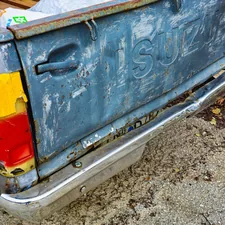 A blue truck with a yellow and red tailgate related to Maximize Your Truck's Utility with a Small Truck Bed Tool Box