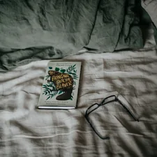 a book sitting on top of a bed next to a pair of glasses related to Unveiling the Perfect Coverlet: A Guide to King Size Comfort