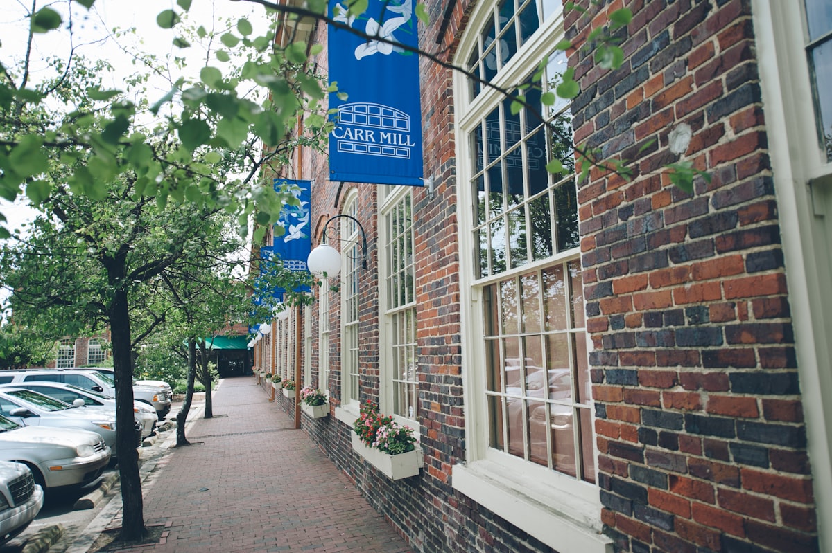a brick building with a blue sign hanging from it's side related to Discover the Charm of BNBs in North Carolina