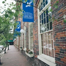 a brick building with a blue sign hanging from it's side related to Discover the Charm of BNBs in North Carolina