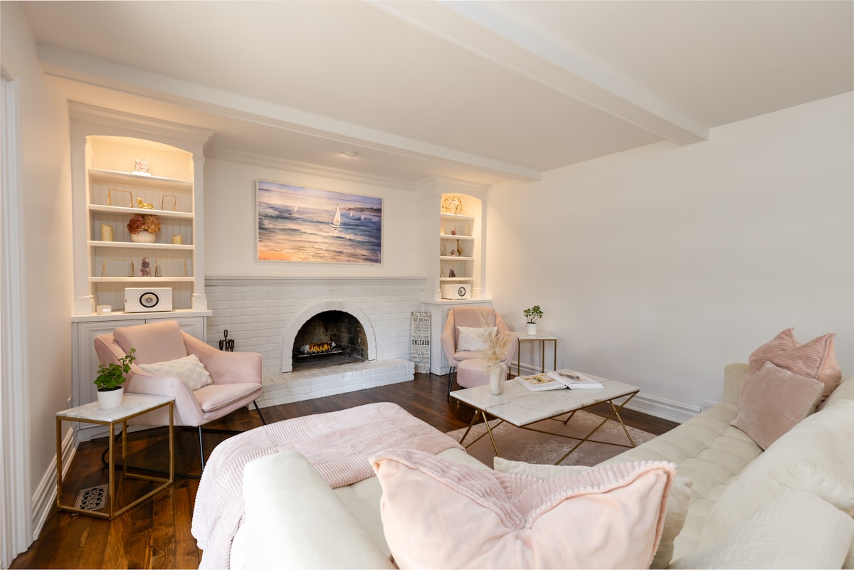 A bright, cozy living room with blush tones, gold accents, and a white brick fireplace, styled for calm and comfort. related to Transform Your Space with Stunning Blue Toile Valances