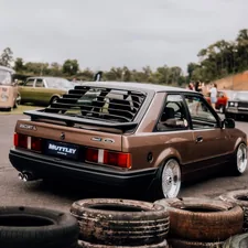 a brown car parked next to a pile of tires related to Upgrading Your MK4 Golf with a Front Valance