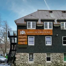a building with a sign that says queen victoria place related to Charming Retreat at Queen Victoria Bed & Breakfast