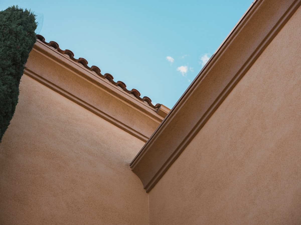 a building with a tree in the front related to Crown Molding Valance: Elegance for Your Windows