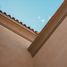 a building with a tree in the front related to Crown Molding Valance: Elegance for Your Windows