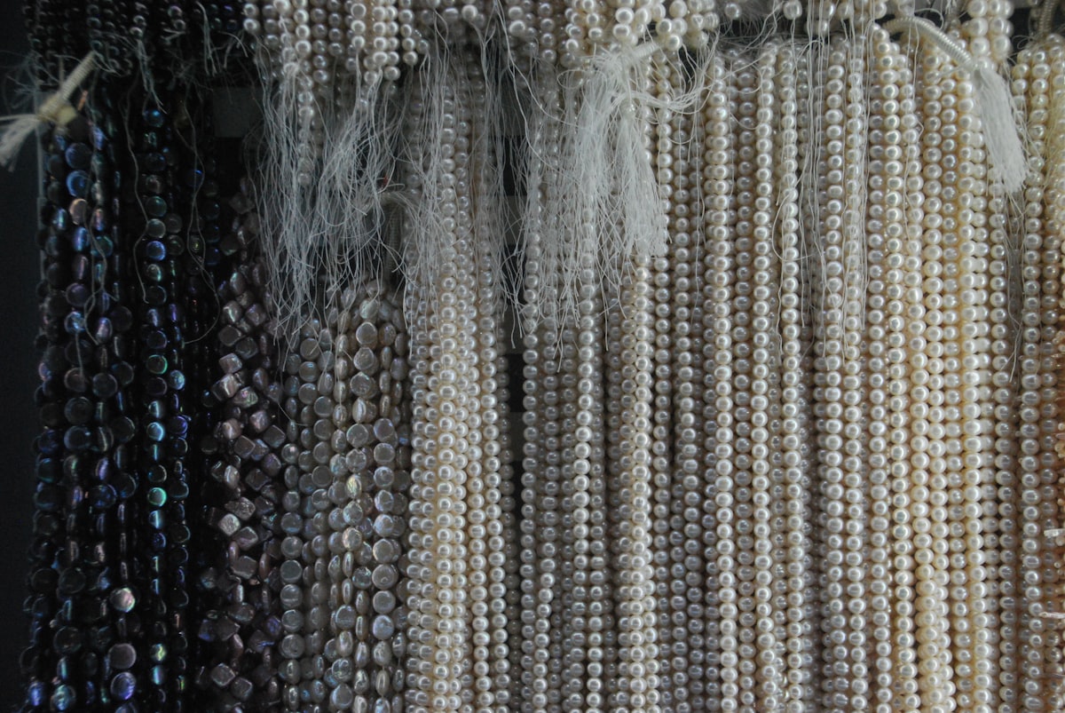 a bunch of beads hanging on a wall related to Beaded Waterfall Valance: Elevate Your Home Decor