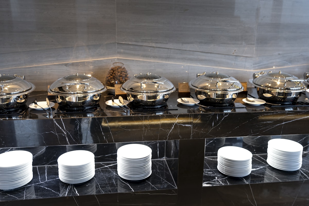 a bunch of plates that are sitting on a table related to Marble Top Sideboards and Buffets: Timeless Elegance for Any Home