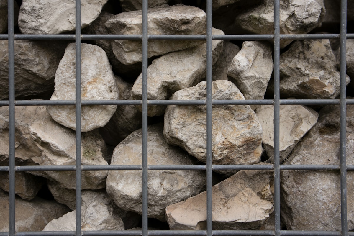 a bunch of rocks that are in a cage related to The Warmth of the Rockies: The Ultimate Guide to Colorado Steel Chimineas