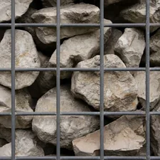 a bunch of rocks that are in a cage related to The Warmth of the Rockies: The Ultimate Guide to Colorado Steel Chimineas