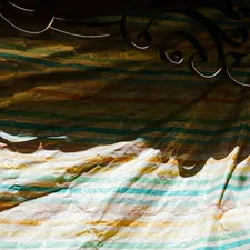 a cat is sitting on a bed in a room related to Striped Window Valances: Add a Pop of Pattern to Your Windows