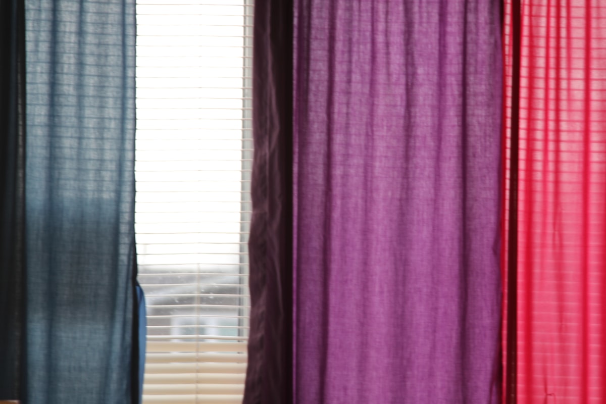 a cat sitting on a chair in front of a window related to Penneys Curtains and Valances Options