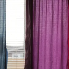 a cat sitting on a chair in front of a window related to Penneys Curtains and Valances Options