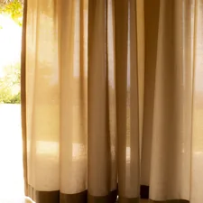 a cat sitting on the floor in front of a window related to Window Curtains & Valances