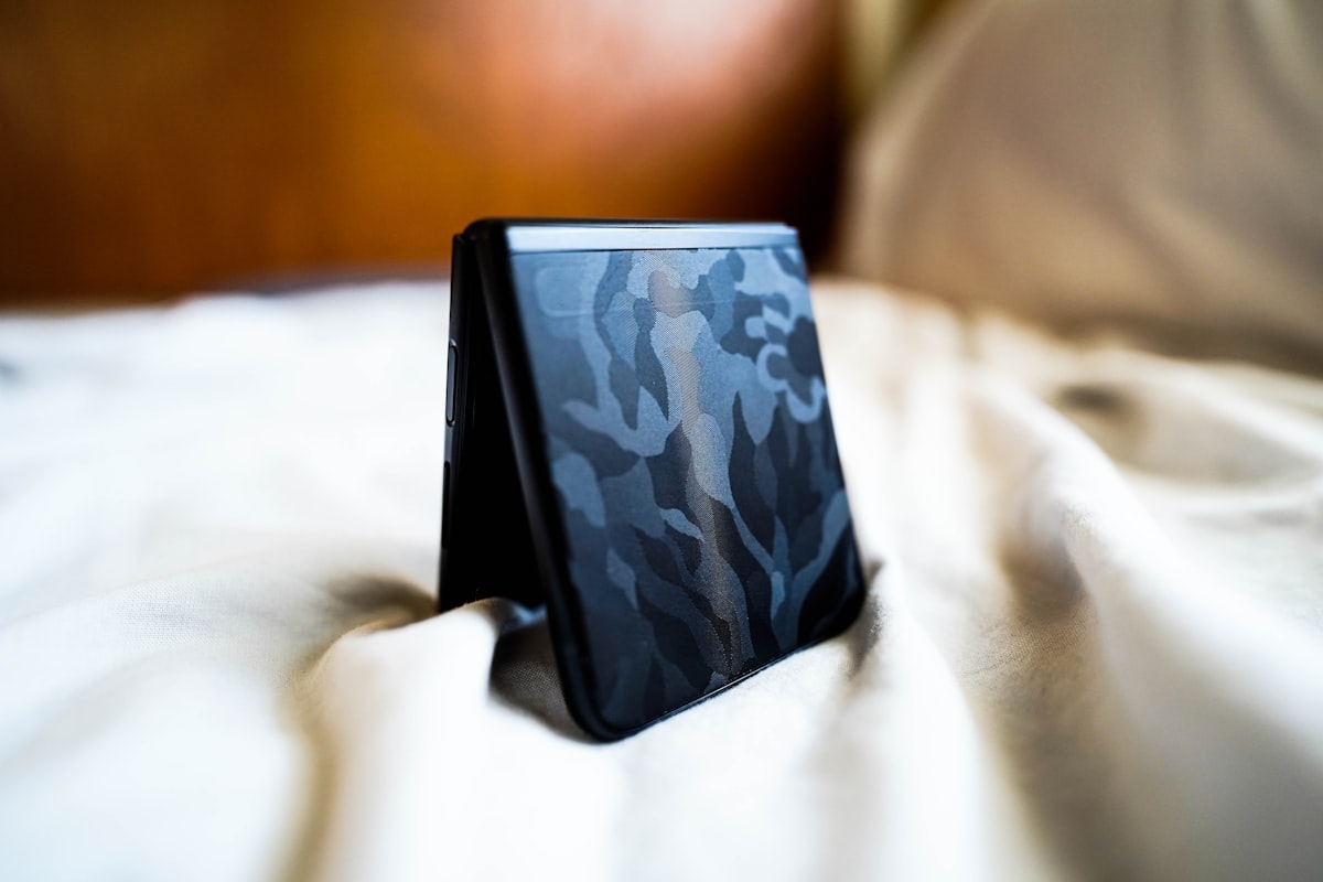 a cell phone sitting on top of a bed related to Transform Your Bedroom with a Blue Camo Bed Set