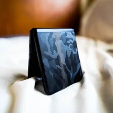 a cell phone sitting on top of a bed related to Transform Your Bedroom with a Blue Camo Bed Set