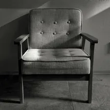 a chair sitting in a room next to a wall related to The Ultimate Guide to Pull Out Bed Chairs: Transforming Spaces with Style and Functionality