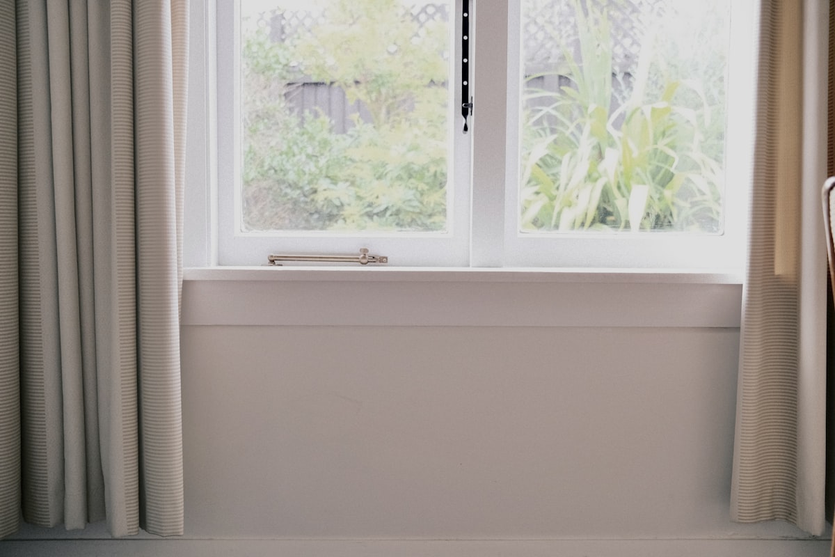 a chair sitting in front of a window related to Elevate Your Window Dressing Game: A Comprehensive Guide to Valance Curtain Rods