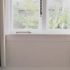 a chair sitting in front of a window related to Elevate Your Window Dressing Game: A Comprehensive Guide to Valance Curtain Rods