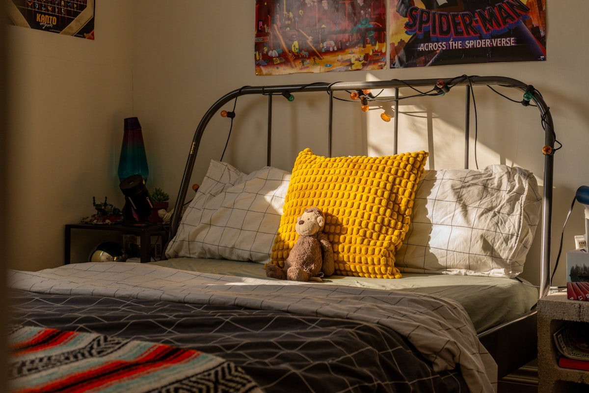 A child's bedroom with a bed and posters. related to Sleek & Sturdy: The Ultimate Guide to Metal Bed Frames