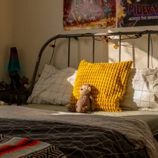 A child's bedroom with a bed and posters. related to Sleek & Sturdy: The Ultimate Guide to Metal Bed Frames