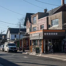 a city street with cars parked on the side of it related to Discovering the Charm of Bed and Breakfasts in Toronto
