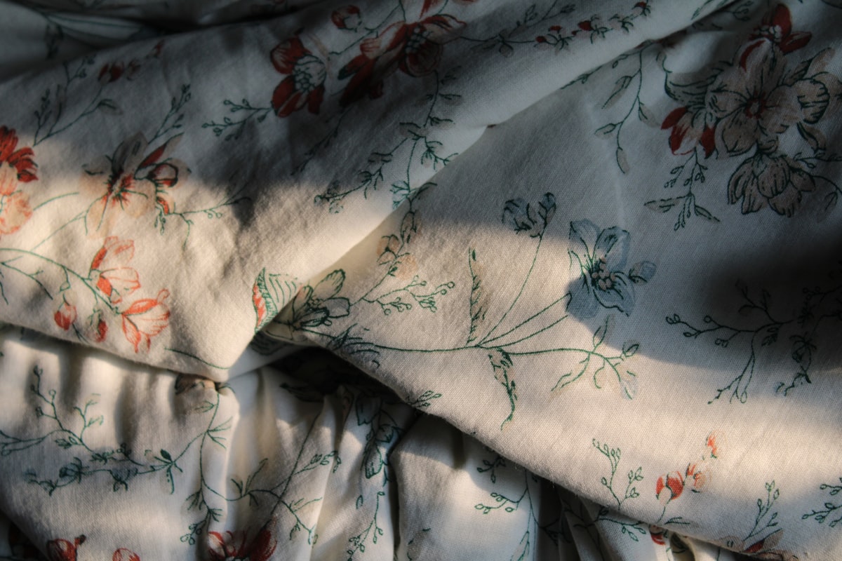 a close up of a bed sheet with a flower pattern related to Elevate Your Bedroom with Shabby Chic Bedding